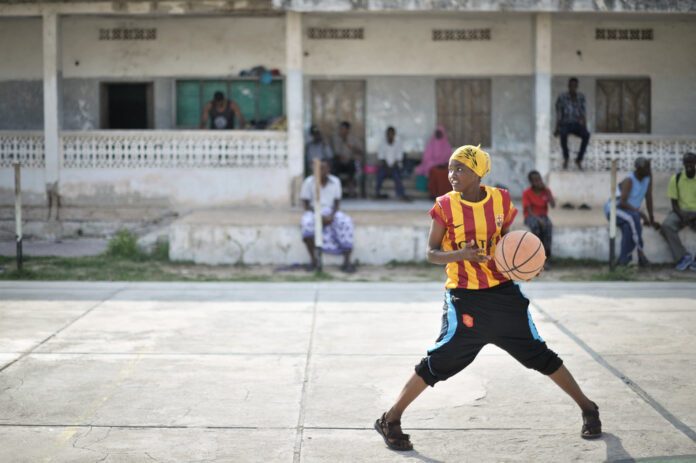 Woman with basketball outdoor court